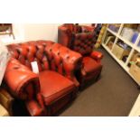 Red leather button backed Chesterfield armchair, wing back chair and footstool.