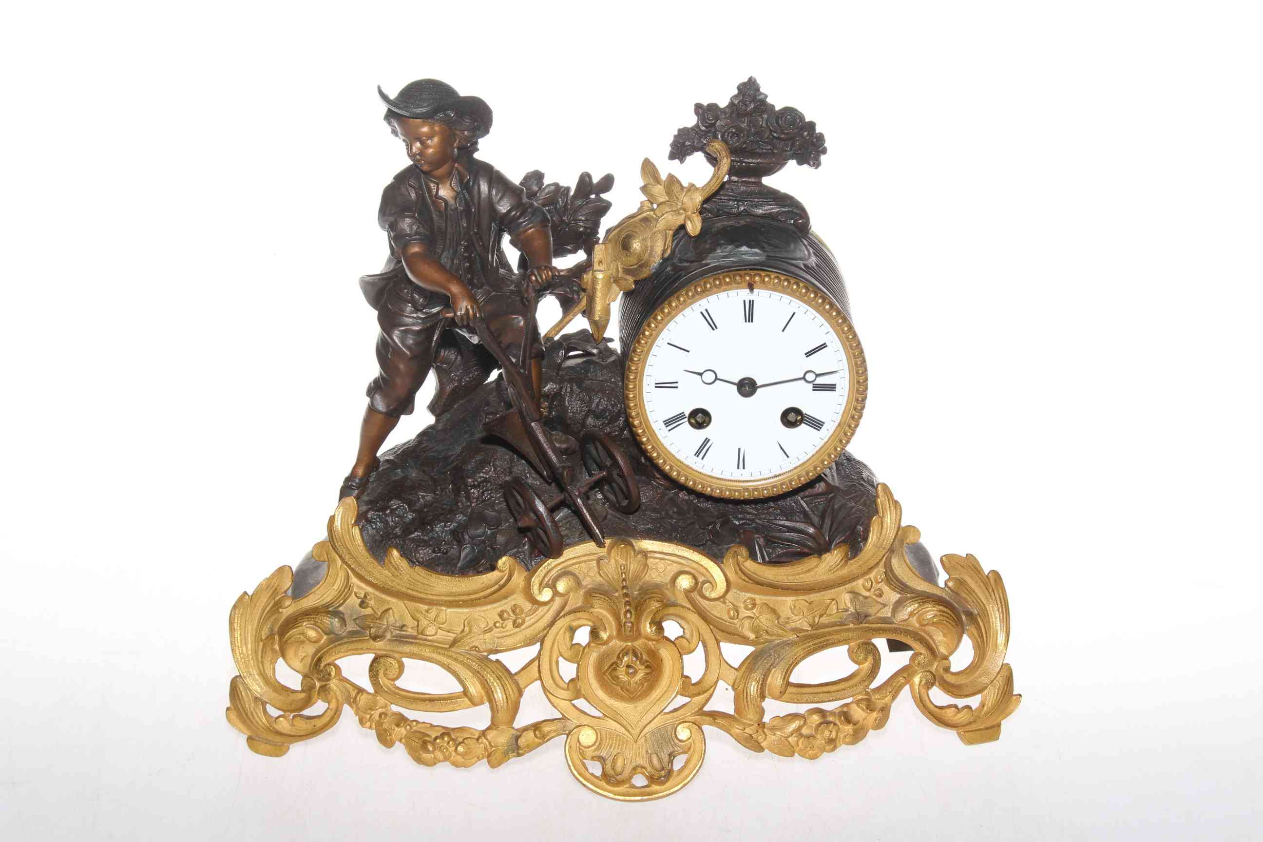 Ornate gilt mantel clock depicting a working young boy, 28cm high.