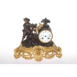 Ornate gilt mantel clock depicting a working young boy, 28cm high.