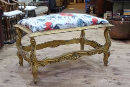 Giltwood stool in floral fabric, 66cm by 106cm by 66cm.