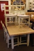 Light oak and sage green rectangular draw leaf dining table and eight bar back dining chairs.