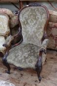 Victorian carved mahogany framed open armchair with serpentine front seat.