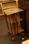 Edwardian oak revolving two tier book table, 89cm by 45cm by 45cm.