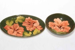 Two pieces of Moorcroft Pottery, hibiscus on green ground.