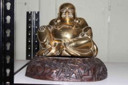 Brass model of a seated Buddha on wood plinth.