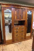 Victorian carved walnut wardrobe having two carved panel central doors above five drawers flanked