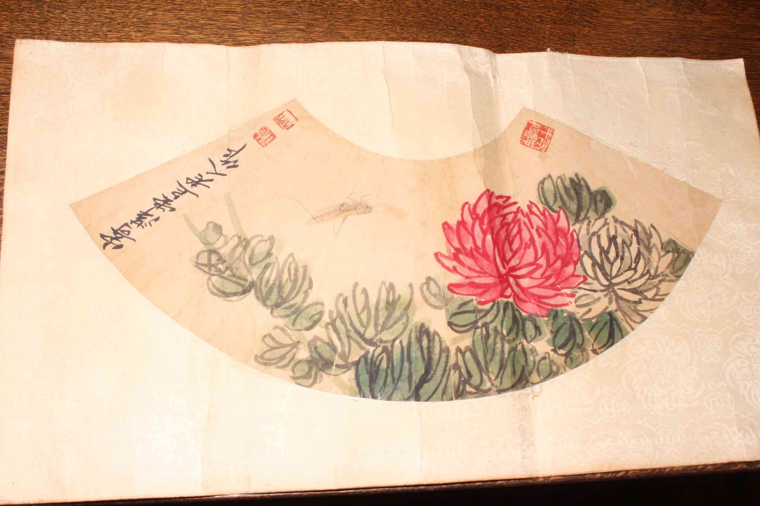 Qi Bashi, fan shaped watercolour of a chrysanthemum, having three seal stamps, unframed,
