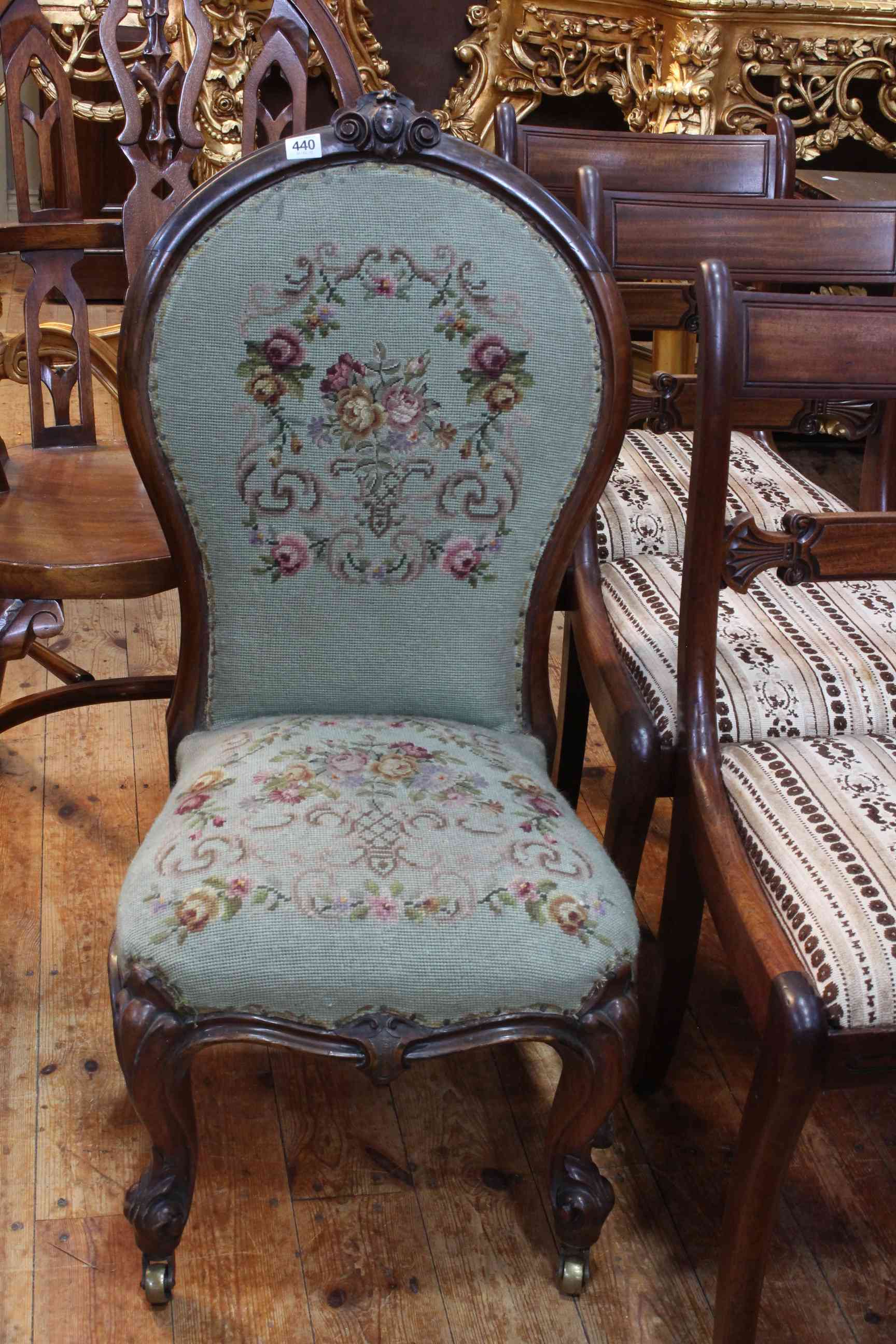 Victorian mahogany framed spoon back nursing chair in floral needlework.