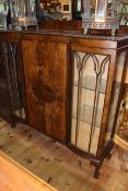 Early 20th Century mahogany inverted serpentine front cabinet bookcase on ball and claw legs,