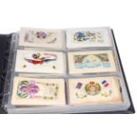 Album of assorted postcards including military embroidered silks, artist signed,