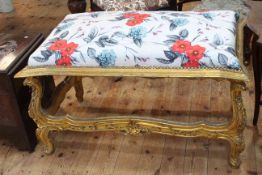 Giltwood stool in floral fabric, 66cm by 106cm by 66cm.