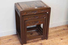 Nest of three Oriental carved hardwood tables (largest 57cm by 44cm by 32cm).