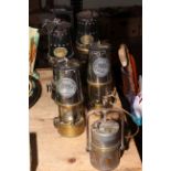 Pair of Patterson and pair of Protector Lamp and Lighting Co. miners lamps and another lamp.