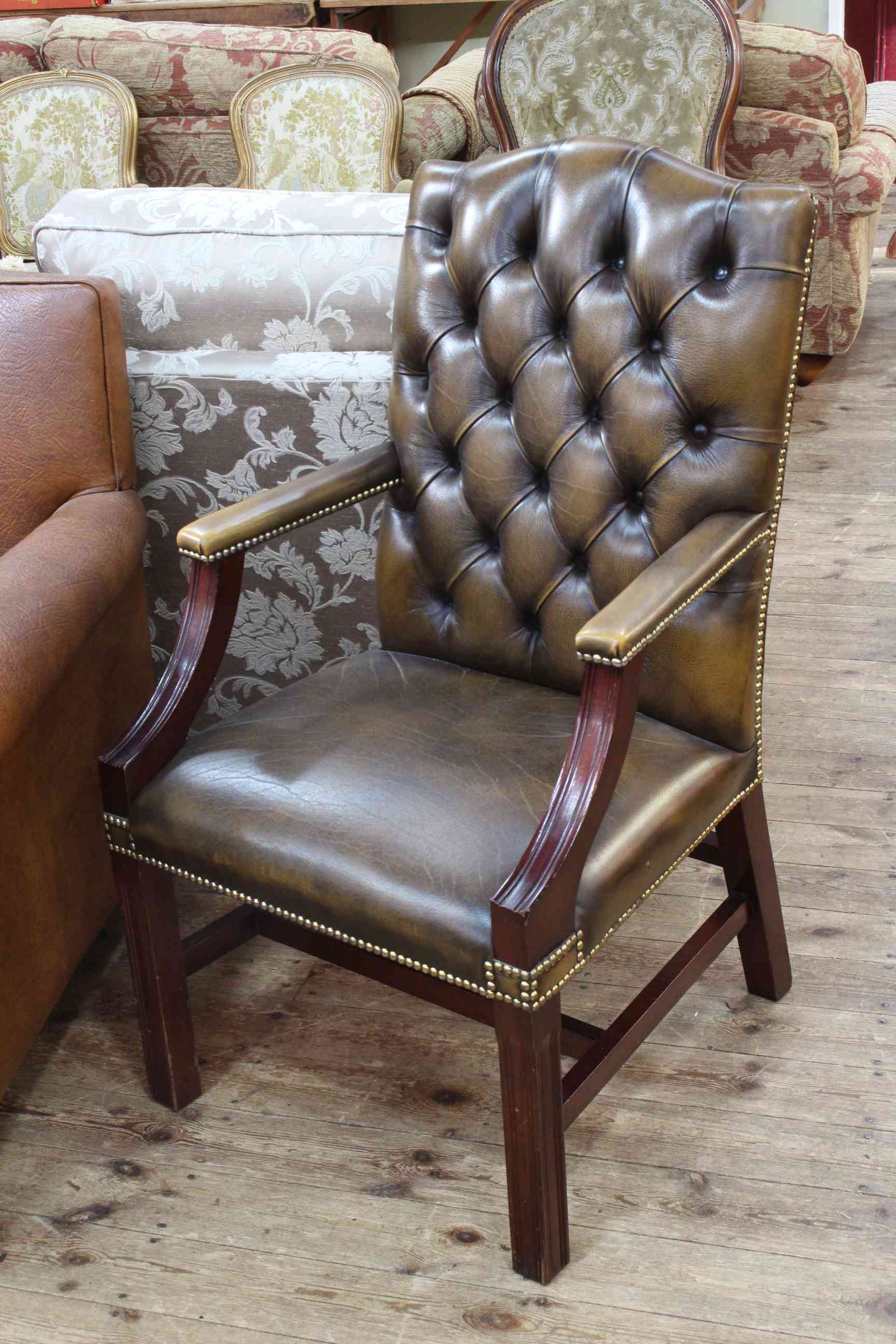 Buttoned leather Gainsborough style library chair.