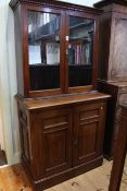 Victorian cabinet bookcase having two glazed panel doors above a base of two panelled doors,