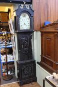Antique carved dark oak 30 hour longcase clock having floral painted arched dial, Henry Steward,