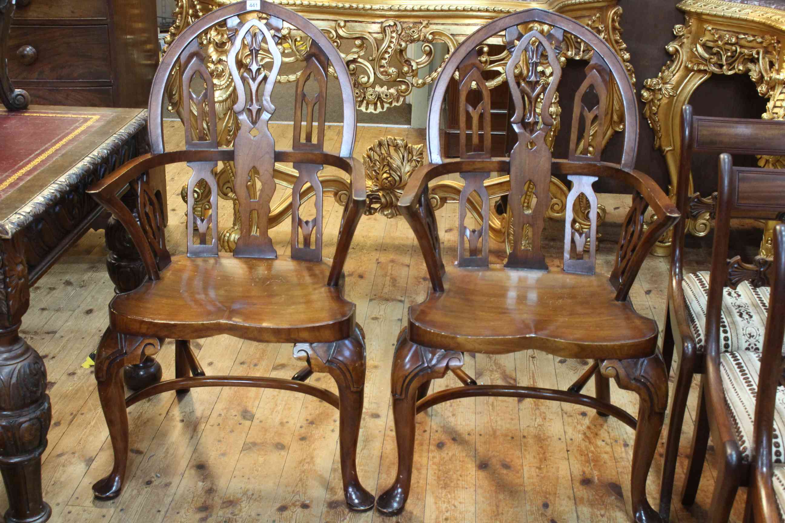 Pair Gothic style Windsor elbow chairs with crinoline stretchers.