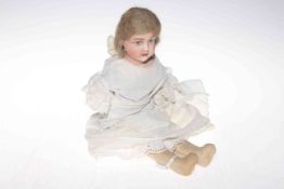 Goss bisque head doll with painted features, bisque lower arms and fabric body, 38cm.