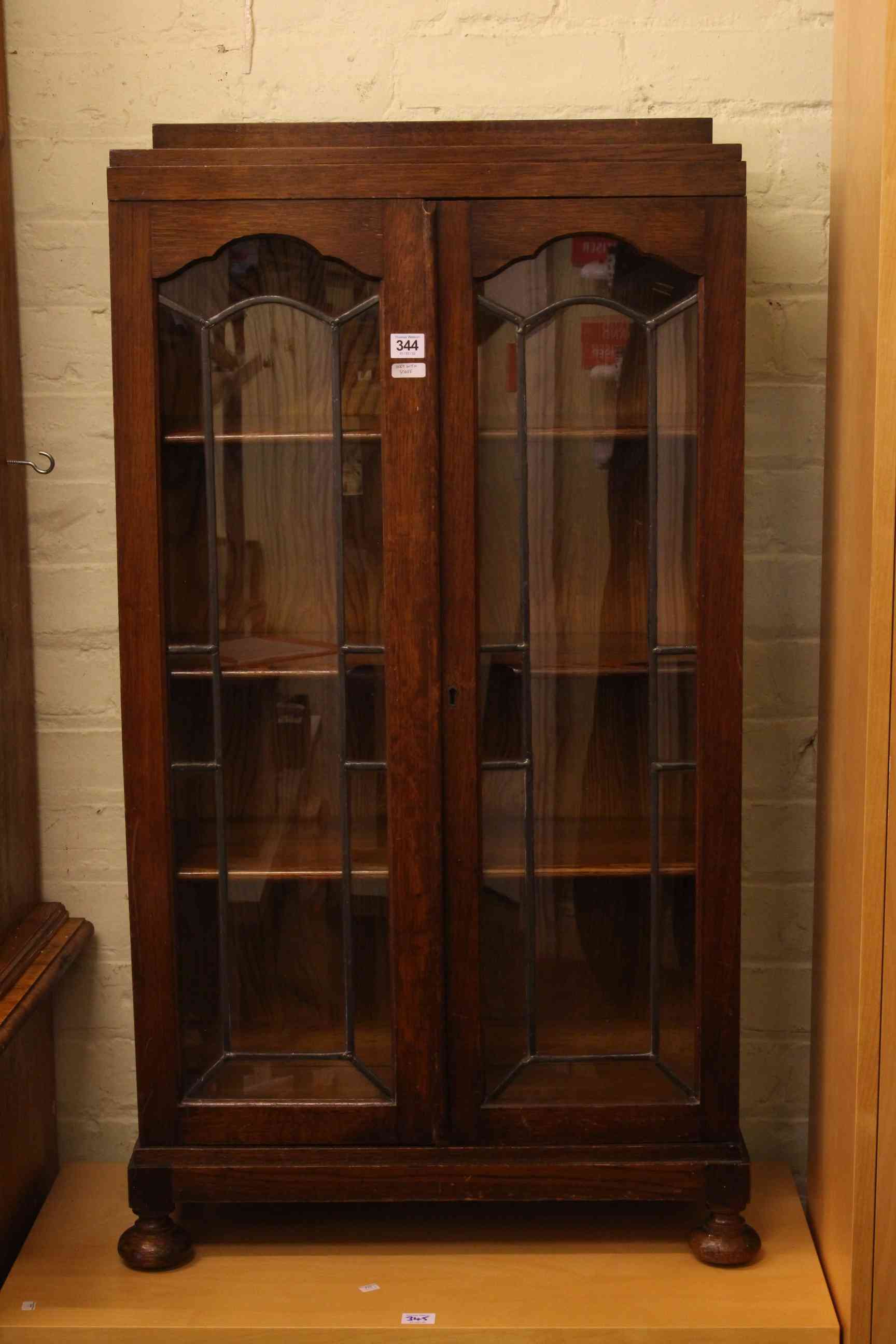 1920's neat oak leaded glazed door bookcase, 110cm by 59cm by 26cm.
