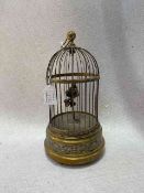 Clockwork automation of a singing bird in cage.