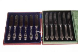 Two cased sets of six silver handled tea knives.