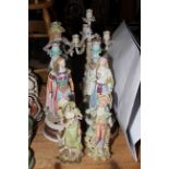 Two pairs and single bisque figures, pair of Continental porcelain woman and cherub candle holders,