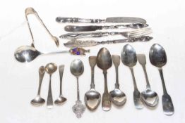 Collection of mostly silver flatware comprising spoons, tongs, butter knives, etc.