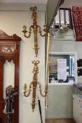 Four large gilt wall lights, 75cm length.