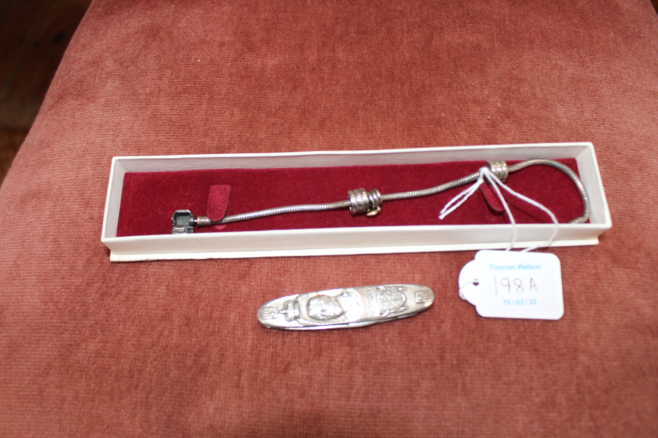 Bracelet marked Pandora and commemorative pen knife.