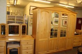 Light wood five piece bedroom suite comprising four door wardrobe, pedestal dressing table,