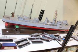 Large battleship on a stand, together with model battleships, ships in glass bottles, pin badges,