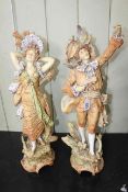 Pair of Continental porcelain figures with musical instruments in colourful costume, 57cm high.