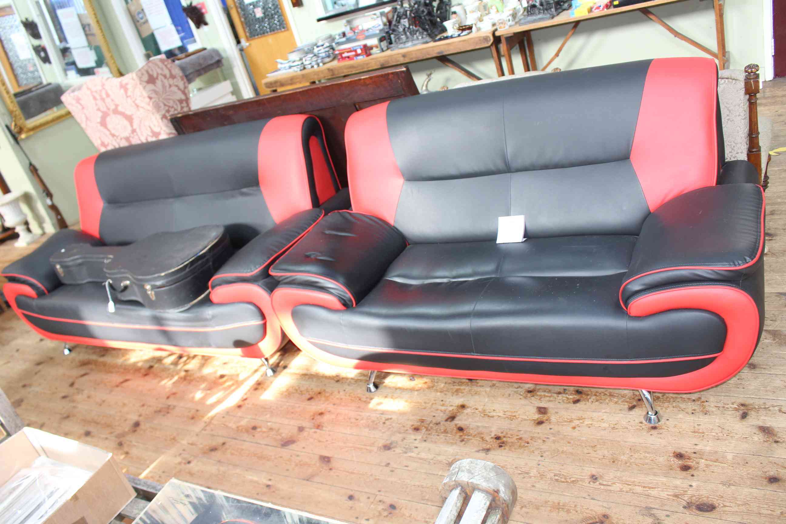 Pair contemporary two tone black and red three seater and two seater settees.