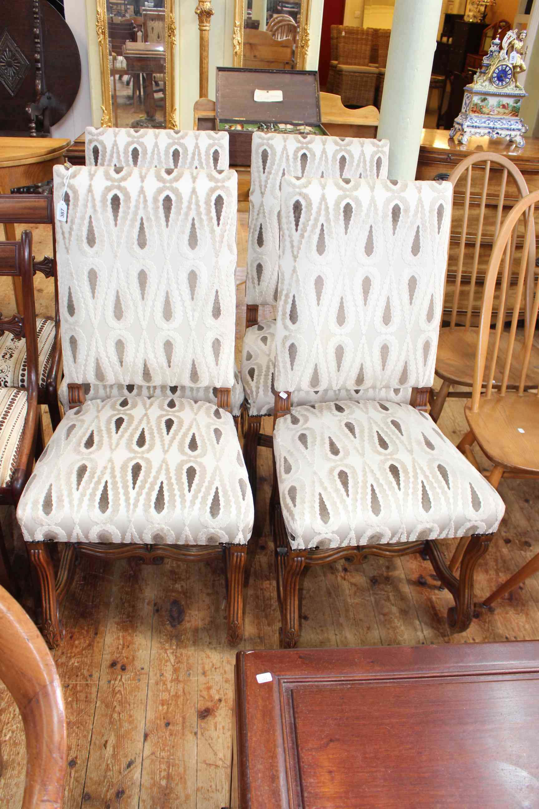 Set of four high backed scrolled leg dining chairs.