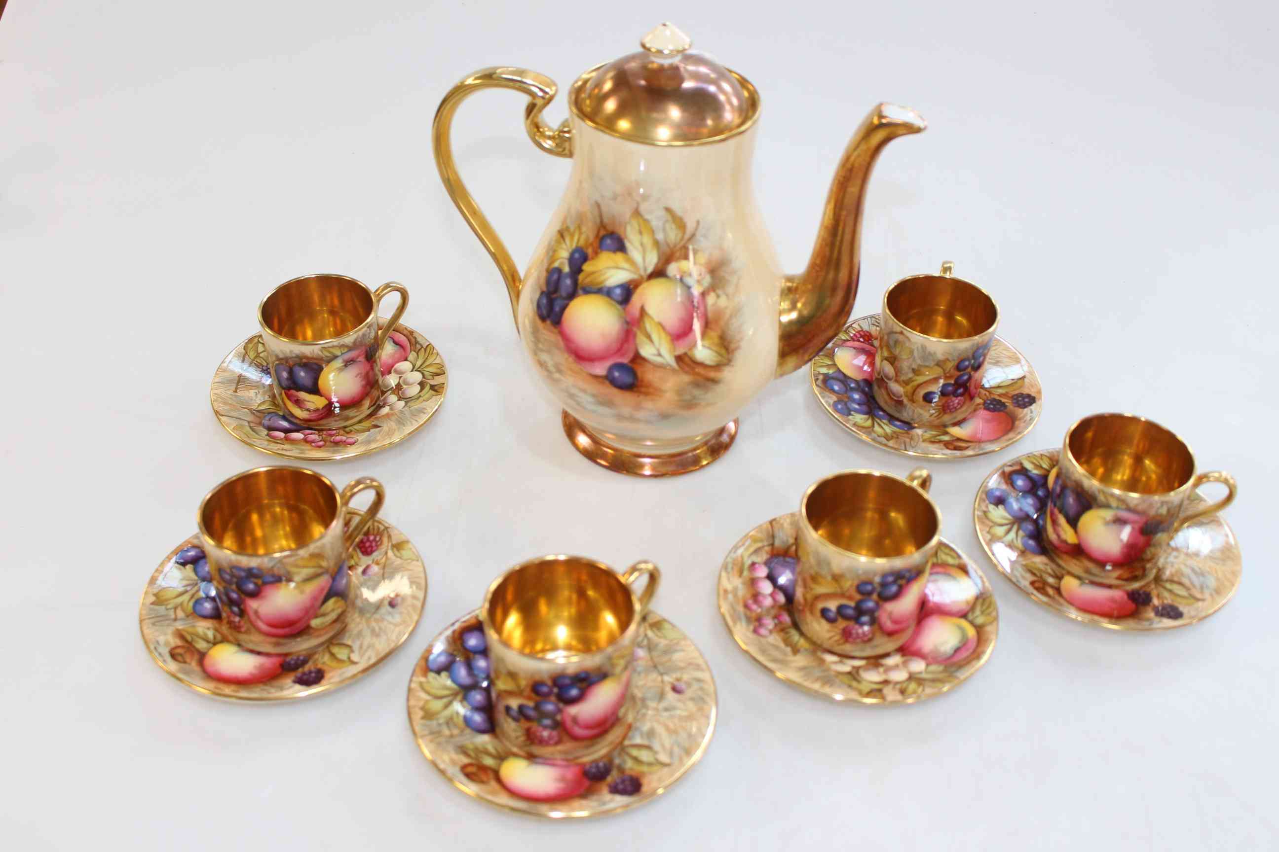 Aynsley Orchard Gold coffee pot, D. Jones, and six coffee cans and saucers, N. Brunt.