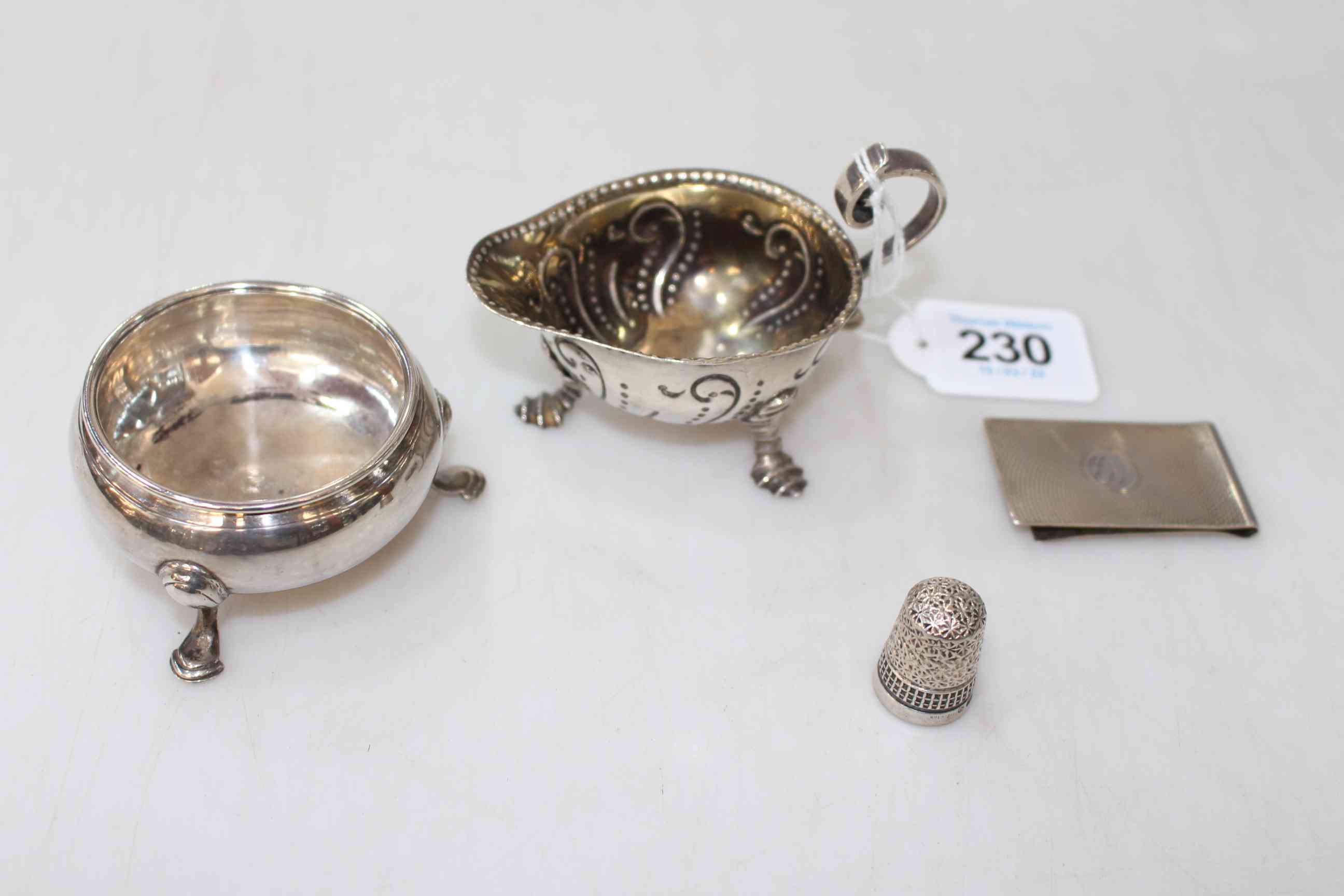 George III silver cauldron salt, small silver jug, engine turned money clip, and thimble (4).