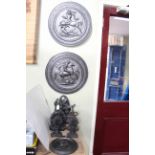 Six cast metal door stops and three wall plaques.