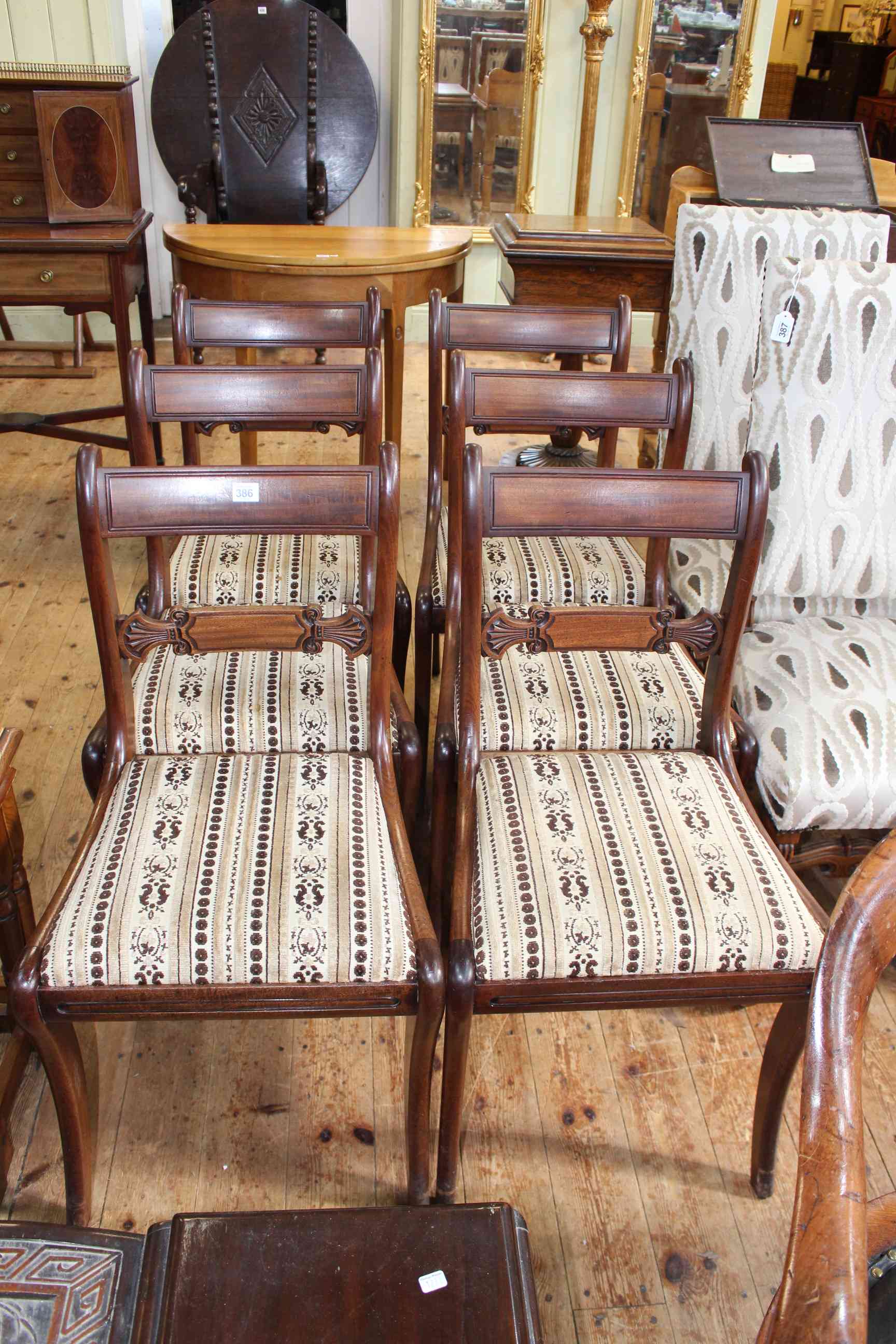 Set of six period mahogany bar back dining chairs on sabre legs.