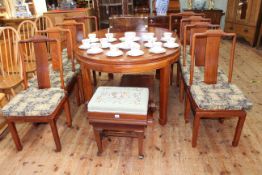 Oriental style rosewood oval extending dining table and two leaves together with eight matching