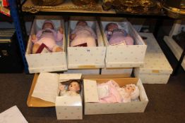 Nine dolls in boxes by Ashton-Drake Galleries.