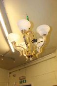 Brass five branch ceiling light and matching double wall light with glass shades.