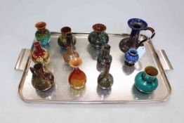 Collection of twelve Linthorpe and other similar small vases and candle holder.