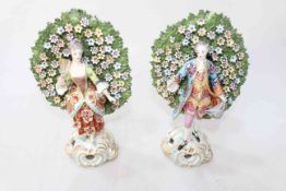 Pair Continental porcelain Chelsea style maiden and gallant figure with bocage background, 22cm.