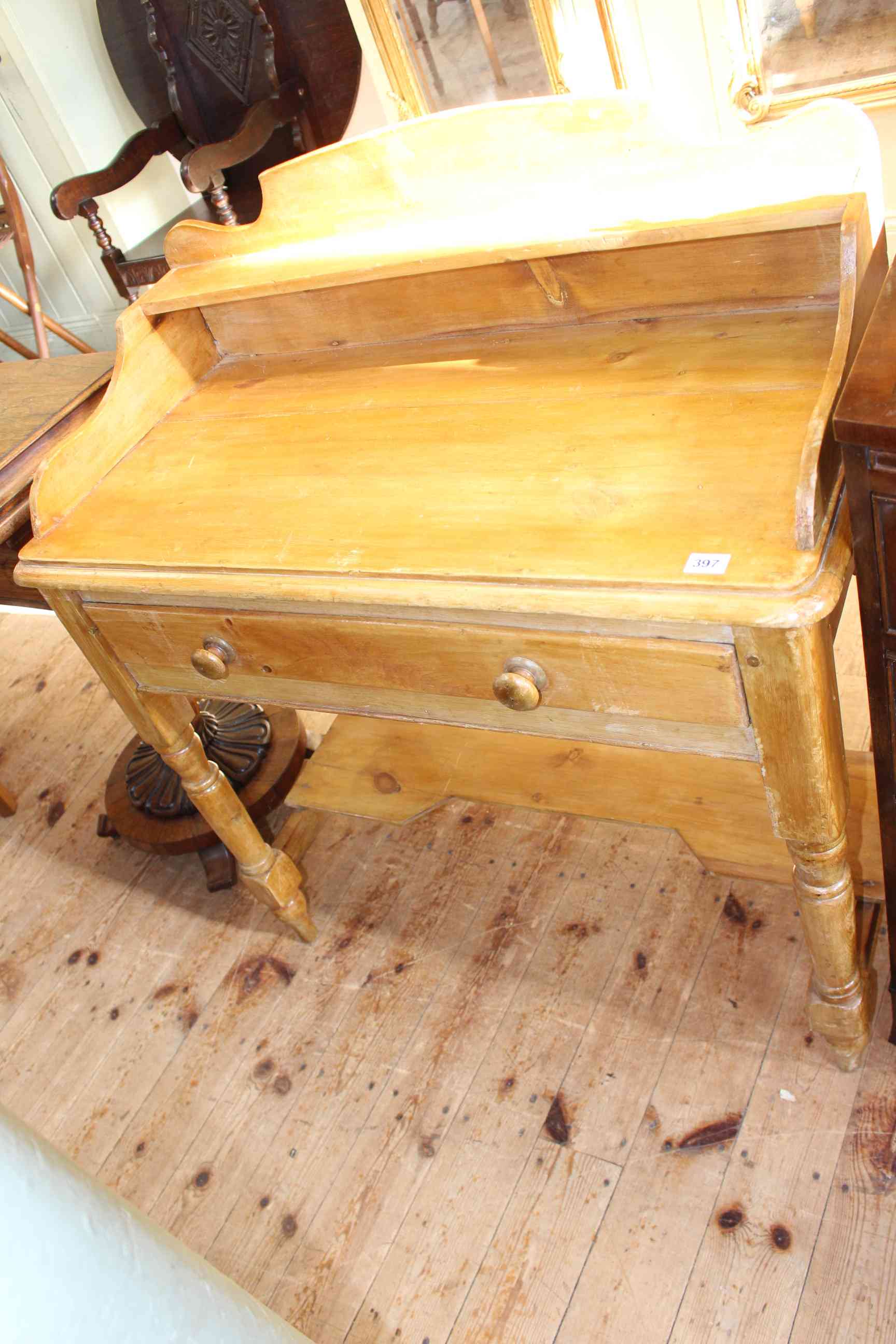 Stained pine 3/4 gallery backed washstand on turned legs, 99cm by 89cm by 45cm.