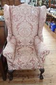 Chippendale style wing armchair on ball and claw legs.