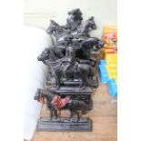 Seven cast metal door stops depicting horses.