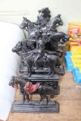 Seven cast metal door stops depicting horses.