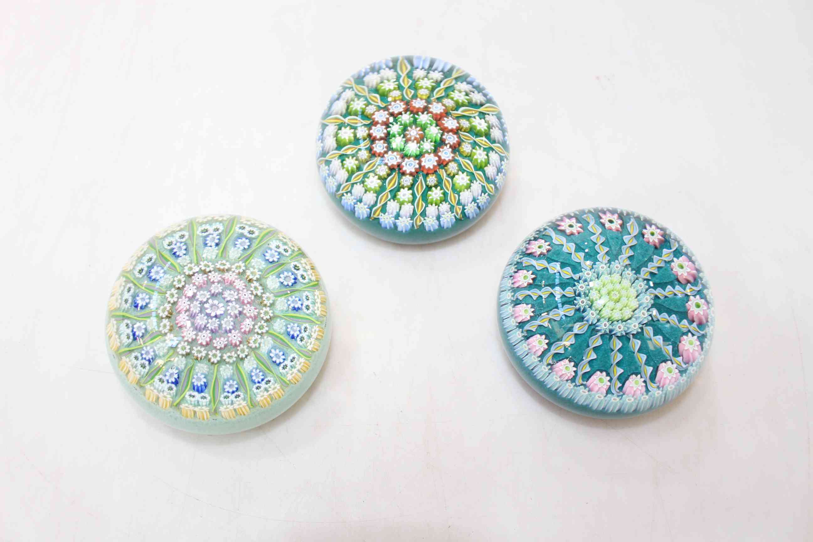 Three Perthshire glass millifiori paperweights.