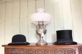 Top hat, bowler hat and Aladdin oil lamp.