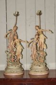 Pair of large painted metal figure lamps bearing musical players, 83cm high.